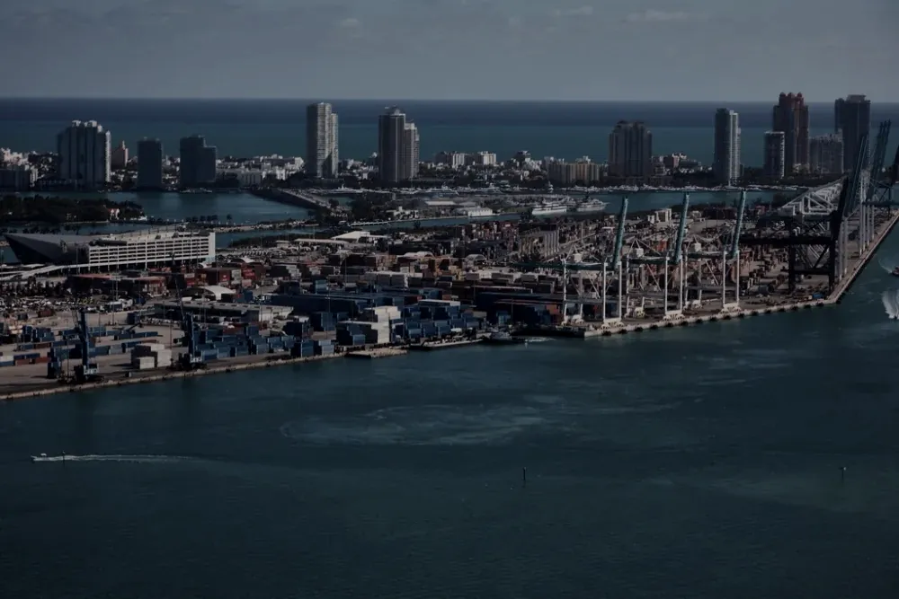 Aerial view of a working port with cranes and container yards