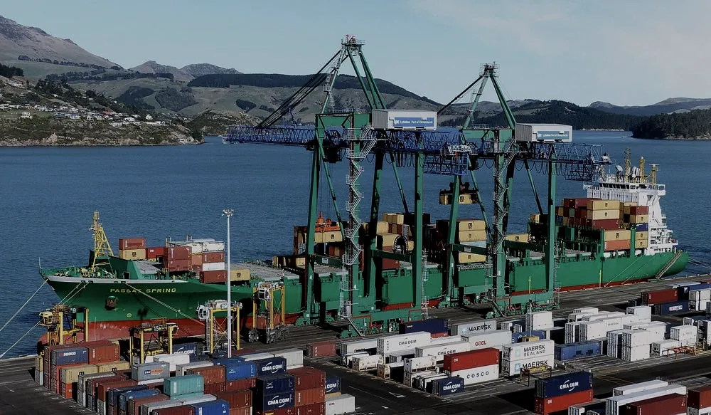 Containers being loaded at a port, representing end-to-end door delivery